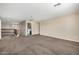 Spacious bonus room with neutral carpeting and access to laundry at 17797 W Carmen Dr, Surprise, AZ 85388