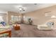 Bright living room featuring a cozy seating arrangement and large windows at 17797 W Carmen Dr, Surprise, AZ 85388