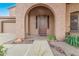 Front entrance with arched entryway and a small porch at 17797 W Carmen Dr, Surprise, AZ 85388