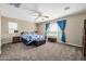 Main bedroom with carpeted floor, ceiling fan and window treatments at 17797 W Carmen Dr, Surprise, AZ 85388