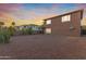 Spacious backyard with desert landscape at sunset at 17797 W Carmen Dr, Surprise, AZ 85388