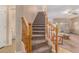 Wooden staircase with a carpeted runner and wooden railing at 17797 W Carmen Dr, Surprise, AZ 85388