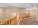 Upstairs hallway with carpeted floor and wooden railing at 17797 W Carmen Dr, Surprise, AZ 85388