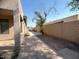 Landscaped backyard with a paved pathway and a block wall at 2515 W Minton St, Phoenix, AZ 85041