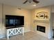 Bright living room featuring a fireplace and large TV at 3028 E Friess Dr, Phoenix, AZ 85032