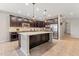 Spacious kitchen with island, stainless steel appliances, and dark wood cabinets at 21243 W Coronado Rd, Buckeye, AZ 85396