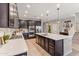 Modern kitchen boasts a large island with seating, stainless steel appliances, and white countertops at 21243 W Coronado Rd, Buckeye, AZ 85396