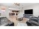Relaxing living room with leather recliners, a large TV, and a fireplace at 21243 W Coronado Rd, Buckeye, AZ 85396