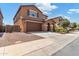 Two-story house with brown exterior, attached garage, and landscaping at 21243 W Coronado Rd, Buckeye, AZ 85396