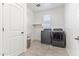 Laundry room with washer, dryer, and storage shelves at 21243 W Coronado Rd, Buckeye, AZ 85396