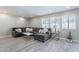 Living room with L-shaped sectional sofa and gray wood-look floors at 8716 E Mitchell Dr, Scottsdale, AZ 85251