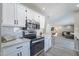 Modern kitchen with stainless steel appliances and white cabinets at 8716 E Mitchell Dr, Scottsdale, AZ 85251