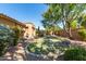 Landscaped backyard with grassy area and trees at 19767 E Thornton Rd, Queen Creek, AZ 85142