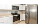 Stainless steel appliances and white cabinetry in kitchen at 19767 E Thornton Rd, Queen Creek, AZ 85142