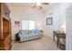 Home office with a blue plaid couch, wooden desk, and built-in shelving at 3285 N 159Th Ave, Goodyear, AZ 85395