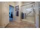 Modern bathroom with a walk-in shower, tiled floor, and ample storage at 3285 N 159Th Ave, Goodyear, AZ 85395