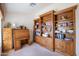 Well-lit office with a desk, filing cabinet, and extensive built-in bookshelves at 3285 N 159Th Ave, Goodyear, AZ 85395