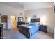Spacious bedroom with a ceiling fan, large windows, and ensuite bathroom at 3285 N 159Th Ave, Goodyear, AZ 85395