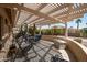 Covered patio with pergola, seating area, and lush landscaping at 3285 N 159Th Ave, Goodyear, AZ 85395
