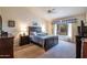 Main bedroom with plush carpeting, ceiling fan and large window at 3285 N 159Th Ave, Goodyear, AZ 85395