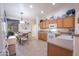 Modern kitchen with wood cabinets, updated appliances, and a breakfast bar at 3285 N 159Th Ave, Goodyear, AZ 85395