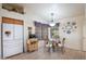 Kitchen features a breakfast nook, white appliances, and wood cabinetry at 3285 N 159Th Ave, Goodyear, AZ 85395