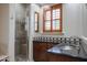 Spa-like bathroom with walk-in shower and granite vanity at 207 N Parkview Ct, Litchfield Park, AZ 85340