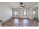 Well-lit bedroom with wood floors, a ceiling fan, and access to other rooms at 207 N Parkview Ct, Litchfield Park, AZ 85340