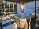 Relaxing hot tub with seating area and patio umbrella at 15576 W Coral Pointe Dr, Surprise, AZ 85374