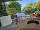 Outdoor kitchen with built-in grill and seating area at 15576 W Coral Pointe Dr, Surprise, AZ 85374