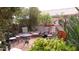 Relaxing patio area with seating, plants, and a hummingbird feeder at 15576 W Coral Pointe Dr, Surprise, AZ 85374