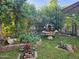 Landscaped backyard with a tiered fountain and lush greenery at 15576 W Coral Pointe Dr, Surprise, AZ 85374