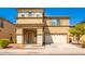 Two-story house with tan exterior, two-car garage, and landscaping at 11210 W Mckinley St, Avondale, AZ 85323
