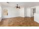 Open living room with tile flooring and ceiling fan at 11210 W Mckinley St, Avondale, AZ 85323