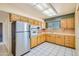 Kitchen with wood cabinets, stainless steel appliances, and tile flooring at 10619 W Clair Dr, Sun City, AZ 85351