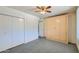 Bedroom with double door closet and ceiling fan at 10619 W Clair Dr, Sun City, AZ 85351