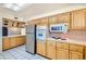 View of kitchen with wood cabinets and stainless steel appliances at 10619 W Clair Dr, Sun City, AZ 85351