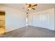 Bedroom with carpet, ceiling fan, and built-in wardrobe at 10619 W Clair Dr, Sun City, AZ 85351