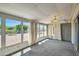 Bright sunroom with multiple windows and backyard view at 10619 W Clair Dr, Sun City, AZ 85351