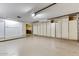 Attached garage featuring storage cabinets and workshop space at 19434 N 130Th Ave, Sun City West, AZ 85375