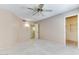 Bright bedroom featuring a ceiling fan and access to a closet at 19434 N 130Th Ave, Sun City West, AZ 85375