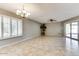 Bright dining room with tile floors and access to a patio at 19434 N 130Th Ave, Sun City West, AZ 85375