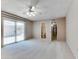 Large bedroom with carpet, ceiling fan, and access to patio at 19434 N 130Th Ave, Sun City West, AZ 85375