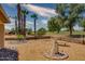 Landscaped backyard with a stone fountain and golf course view at 19434 N 130Th Ave, Sun City West, AZ 85375