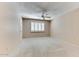 Spacious bedroom with ceiling fan and window shutters at 19434 N 130Th Ave, Sun City West, AZ 85375