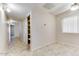 Hallway with tile floors and built-in storage at 19434 N 130Th Ave, Sun City West, AZ 85375