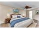 Virtually staged main bedroom with a king-size bed and ensuite bathroom at 19434 N 130Th Ave, Sun City West, AZ 85375
