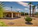 Backyard features a covered patio, gravel landscaping, and mature plants at 19434 N 130Th Ave, Sun City West, AZ 85375