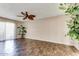 Living room with dark tile floors and ceiling fan at 19434 N 130Th Ave, Sun City West, AZ 85375