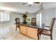 Dining area with granite island and wood cabinetry at 19434 N 130Th Ave, Sun City West, AZ 85375